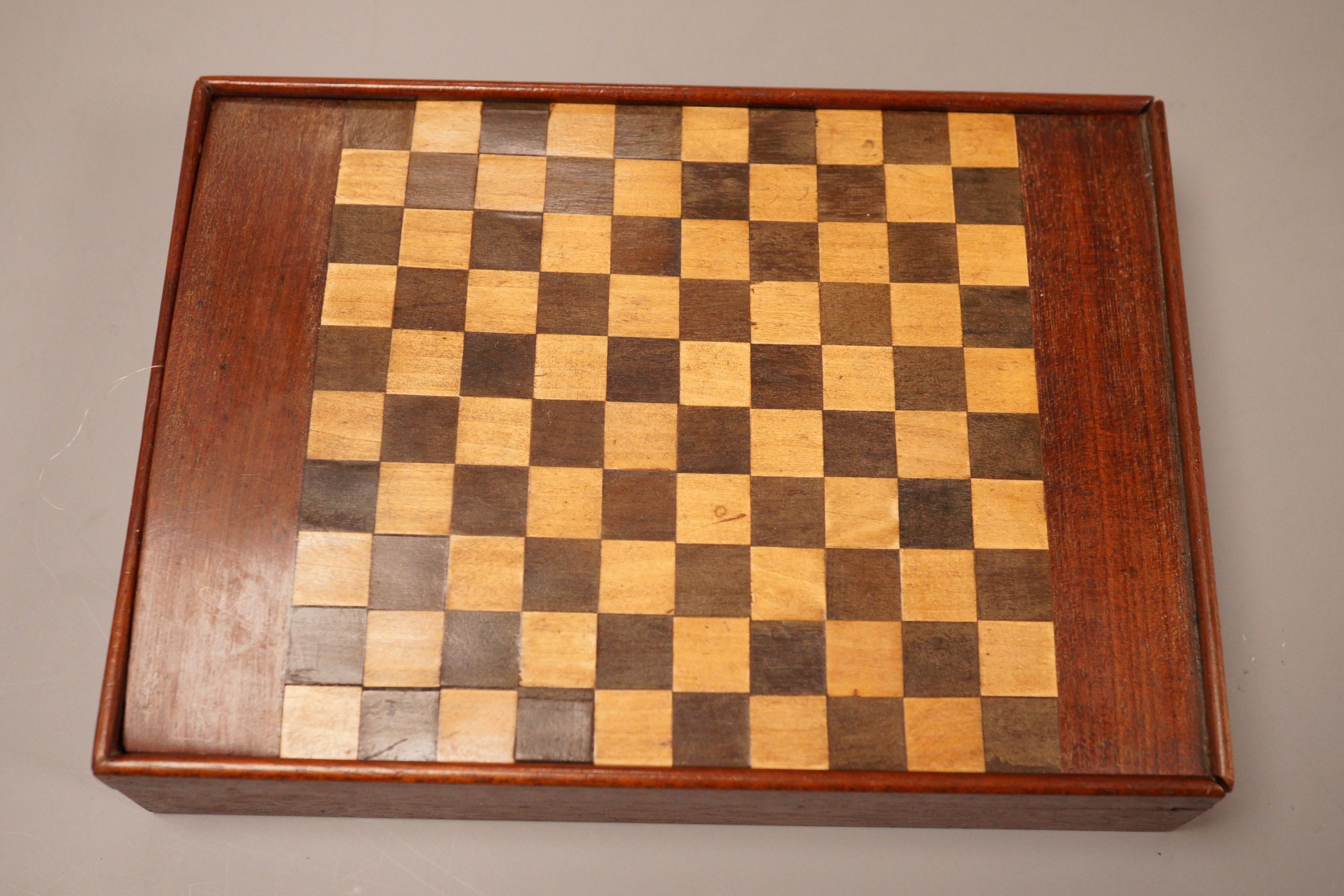 A miniature 19th century games compendium with carved bone playing pieces